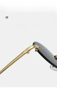 Macro detail of rimless sunglasses featuring gold metal temples and super elastic texture