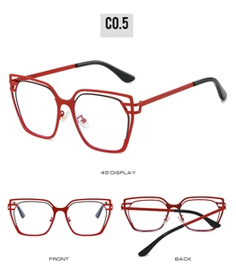 Detail view of red cat-eye glasses frame with hollow metal structure and adjustable nose pads