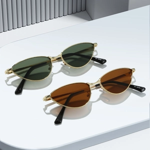 Retro cat-eye sunglasses with gold metal frames and dark green or amber lenses