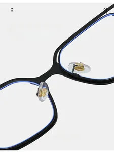 Detailed macro view of comfortable silicone nose pads with gold metal base on black frames