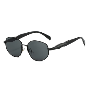 Vintage round metal frame sunglasses with dark grey lenses in a sleek minimalist style