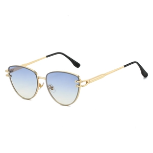 Lunettes de soleil œil de chat modernes avec monture dorée et verres dégradés bleu-jaune