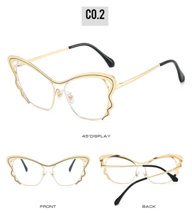 Detail of golden butterfly wing glasses frame with stylish wave edges and black tips