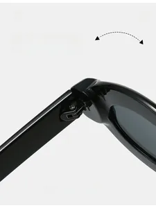 Close-up of reinforced metal hinges on stylish oval thick-frame sunglasses