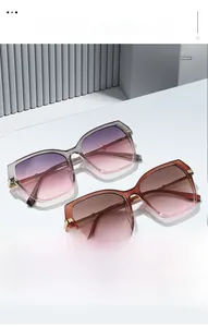 Detail of square oversized sunglasses with gradient lenses and gold metal accents