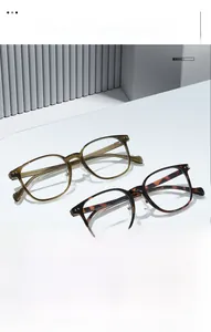 Macro view of retro thick square frame glasses in tortoise shell and olive green