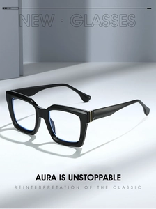 Detail of square black frame glasses featuring gold metal accents and blue light coating