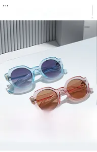 Detail of trendy resin sunglasses with sky blue and pink frames on a white surface