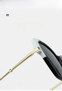 Detailed macro view of black and blue square sunglasses with gold metal temple hinges
