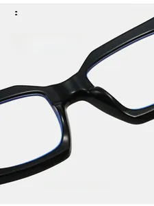 Macro detail of integrated nose pads on black square frame glasses with blue inner trim