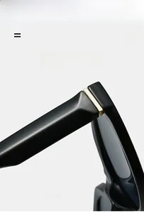 Close-up of golden metal hinges on black polished sunglasses frame detailing texture