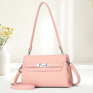 Pink pebbled leather shoulder bag with silver turn-lock and adjustable strap