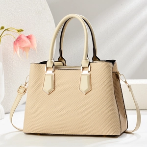 Chic beige woven tote bag with cream leather handles and gold metal hardware detail