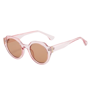 Fashionable cat-eye sunglasses with pink translucent frame and amber lenses shown at 45-degree angle