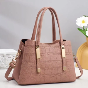 Dusty rose crocodile pattern handbag with golden H-shaped hardware and shoulder strap