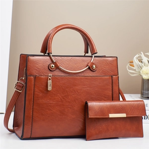 Caramel brown large tote bag and matching clutch set with round metal handles and strap