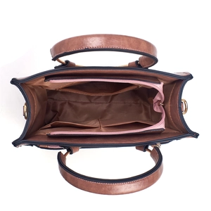 Top view of brown handbag interior showing compartments with pink zipper and soft lining