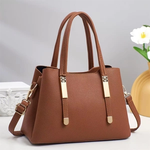 Brown lychee leather tote bag with gold H hardware and adjustable shoulder strap