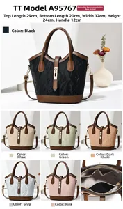 Detail of marble texture bucket bag with leather trim and gold metal twist lock buckle