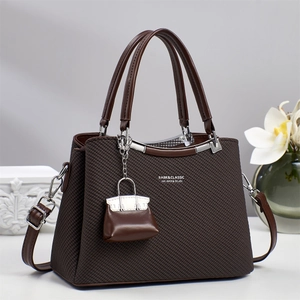 Dark brown twill crossbody handbag with dual handles and silver hardware