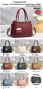Detailed view of leather handbag with dimensions 25x12x18cm and matching mini coin purse