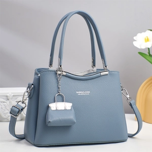 Elegant grey-blue leather handbag for middle-aged women with pebble texture and mini charm