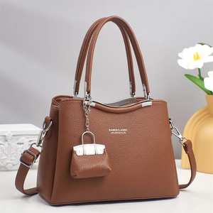 Close-up of brown litchi pattern leather tote bag with silver hardware and tulip decor