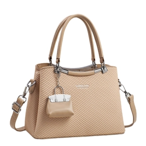 Elegant beige woven texture handbag with top handles and a matching mini pouch charm