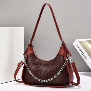 Fashionable burgundy crescent underarm bag with chic metal chain and textured grid pattern