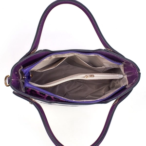 Detailed interior of purple patent leather crossbody bag with multiple compartments