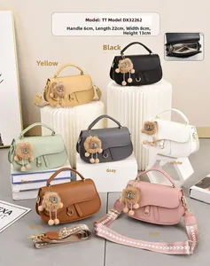 Detailed view of multi-color saddle shoulder bags with plush lion pendant 22x8x13cm