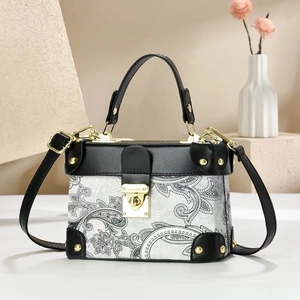 Elegant white paisley print box bag with black leather trim and gold metal clasp