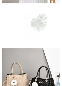 Detail of stylish tote bag featuring logo print, round handles, and soft pompom charm