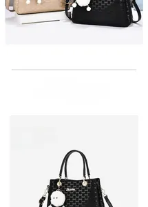 Detailed macro view of embroidery texture and metal rings on a large capacity tote bag