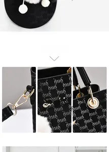Detail of black monogram handbag showing gold hardware, logo texture and white fur charm