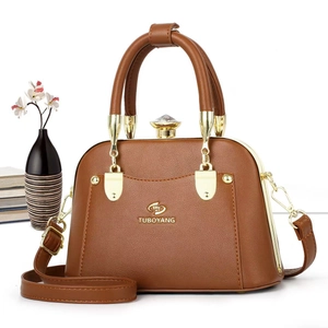 Deep brown PU leather tote bag with crystal knob and gold hardware on white background