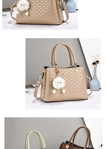Detailed close-up of textured leather handbag with gold ring handle and plush charm