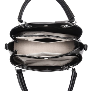 Overhead view of large black leather handbag showing three spacious inner compartments
