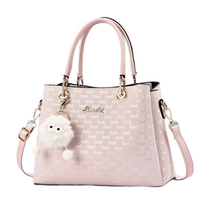 Pink faux leather tote bag with embossed textures and a white plush pompom charm