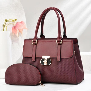Detail of burgundy tote bag set featuring woven texture fabric and golden twist lock