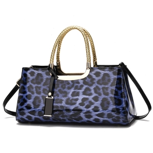 Blue leopard print tote bag with glossy finish and gold spiral metal handles