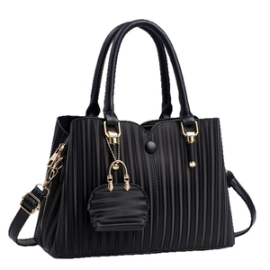 Elegant black pleated handbag for women with gold hardware and a matching mini coin pouch