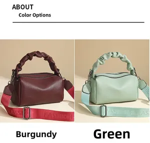 Detail view of burgundy and green leather pillow bags with pleated handles and fashion straps