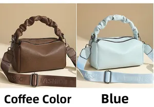 Detail of coffee and blue leather bags with lychee pattern and ruched ring handles