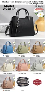 Detail view of leather tote with star charm and multi-compartment interior dimensions
