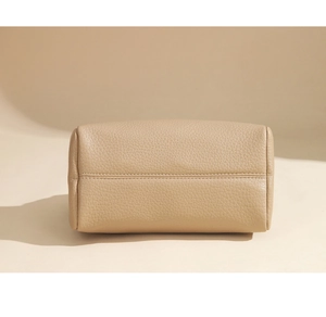 Close-up of beige lychee textured leather bottom with reinforced double stitching detail