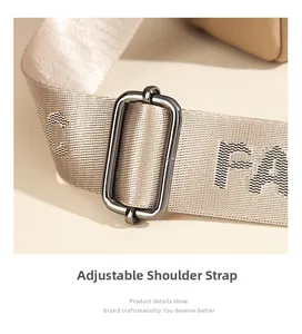 Detail of adjustable champagne fabric shoulder strap with gunmetal buckle and jacquard texture