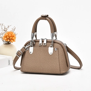 Detailansicht der strukturierten Stofftasche mit Silberbeschlägen und Doppelgriffen