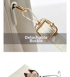 Detail of white litchi pattern leather bag with detachable gold metal hook buckle