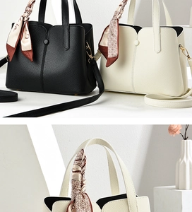 Detail of lychee pattern leather tote bags with decorative silk scarf handles and gold hooks